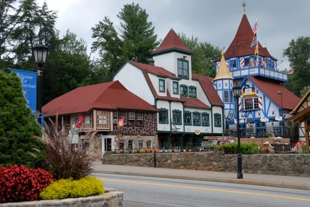 Bavarian alpine-style buildings with red roofs and flags in downtown Helen, Georgia